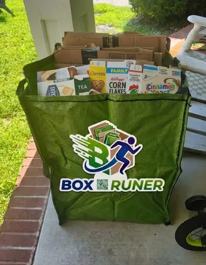 A Box Runner tote filled with flattened cardboard and paper boxes